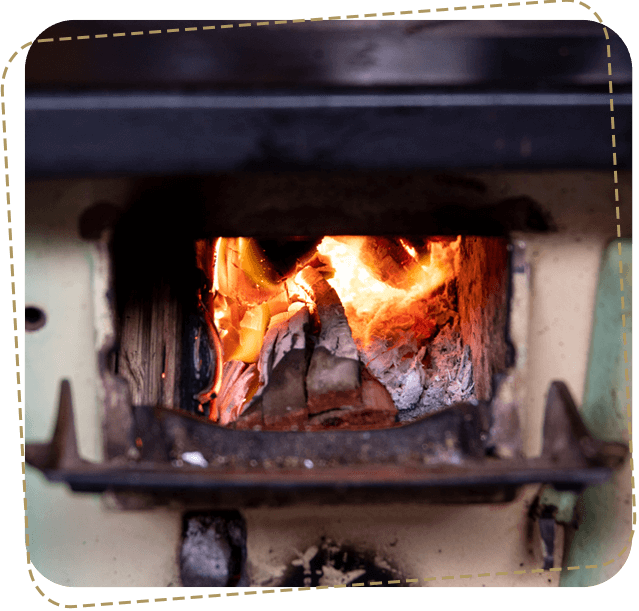 A fire burning in an old fashioned stove.