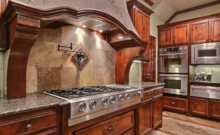 A kitchen with wooden cabinets and stainless steel appliances.